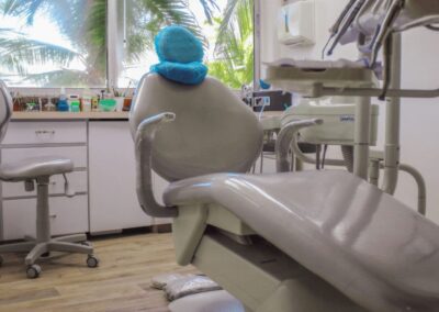 Dentist Cartagena's Office - Modern dental chair in an office with palm trees outside the window