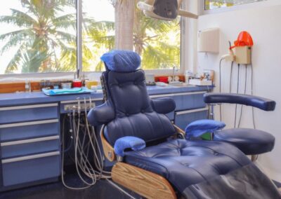 Dentist Cartagena's Office - Luxurious dental chair in an office with palm trees outside the window